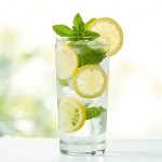 Fresh-glass-of-lemon-water-with-lemon-slices-mint-leaves